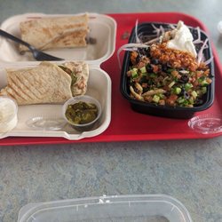 Pita Land - Chicken and Steak wrap mixed. Chicken and steak bowl mixed. Both dishes have a spicy red sauce and garlic sauce.