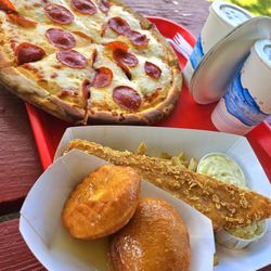 A large pizza, and fish fry with honeybuns, coleslaw and fries.