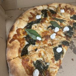 Disappointingly dry white pizza with chicken, 30¢ worth of spinach, 20¢ worth of ricotta, and nowhere near enough cheese.. Disappointingly dry white pizza with chicken, 30¢ worth of spinach, 20¢ worth of ricotta, and nowhere near enough cheese..