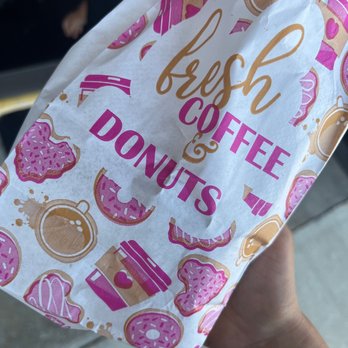 Donut Palace - a person holding a bag of donuts - Donuts Near Me - Duncanville, Texas