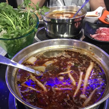 Nine Spices Fondue - Spicy Soup Broth (with some food items cooking) - Hot Pot Near Me - Gainesville, Florida Nine Spices Fondue - Spicy Soup Broth (with some food items cooking) - Hot Pot Near Me - Gainesville, Florida