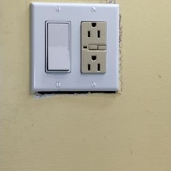 Econo Lodge - Electrical outlet next to bathroom sink not attached properly.