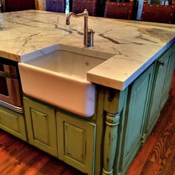 Delta Granite - Calcatta Macchia Vecchia marble installed with miter edge profile and farmhouse sink.