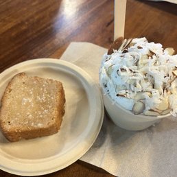 One scoop of piña ice cream and one scoop of strawberry with a warmed up piece of lemon pound cake.