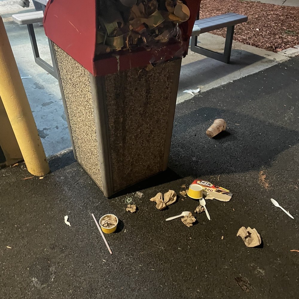 Garbage filled to the top while 6 workers were inside doing nothing.