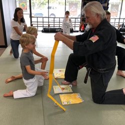 United Studios of Self Defense - Receiving their yellow belts from Teacher Caldwell