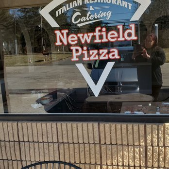 Newfield Pizza - a man taking a picture through the window - Pizza Near Me - Middletown, Connecticut