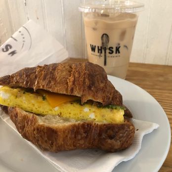 Whisk - Bacon, egg and cheese on a croissant and an iced vanilla latte. - Bakeries Near Me - Richmond, Virginia Whisk - Bacon, egg and cheese on a croissant and an iced vanilla latte. - Bakeries Near Me - Richmond, Virginia