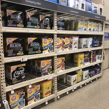 PetSmart - Shelves at PetSmart in Oswego, IL, are stocked with multiple brands and types of cat litter, including clumping, multi-cat, odor control, and double duty options. The products are organized on metal shelving units with labels and packaging visible, and the store environment appears clean and well-maintained. - Pet Stores Near Me - Oswego, Illinois