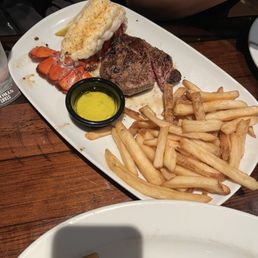 Flo's filet with lobster tail and a side of fries.