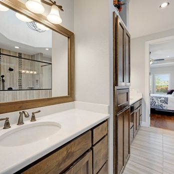Top Renovation - a bathroom with a sink and a large mirror - General Contractors Near Me - Los Angeles, California Top Renovation - a bathroom with a sink and a large mirror - General Contractors Near Me - Los Angeles, California