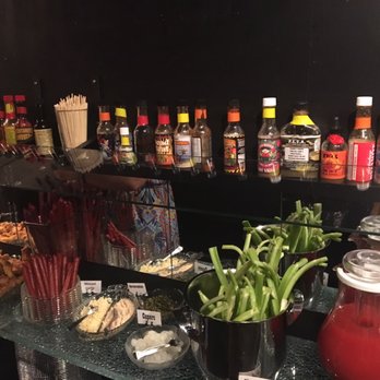 Hell's Kitchen - Hot sauce lines the whole bar! - New American Near Me - Minneapolis, Minnesota