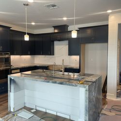 GTL Construction - Changed door and drawer covers to shaker style and added soft close. Ijen blue quartzite waterfall edge island.