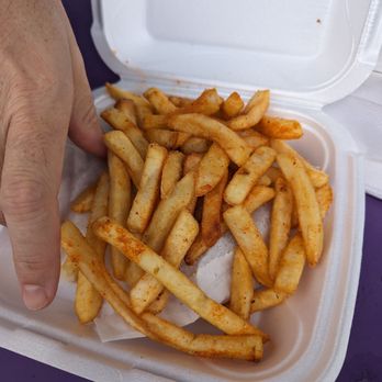 Yaba - a person holding a container of french fries - Mediterranean Near Me - Raleigh, North Carolina