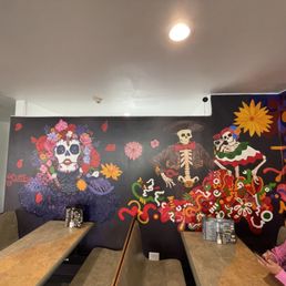 a woman sitting at a table in a mexican restaurant
