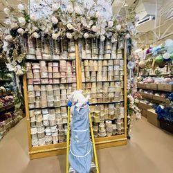 Daisy helping restock the ribbon wall. Arcadia carries hundreds of ribbon styles for custom arrangements and DIY projects.
