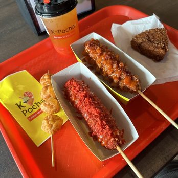 K-Pocha - Left to right: shrimp skewer, hot cheeto corn dog, passionfruit jasmine tea, potato corn dog, kim-cheese fried rice ball - Korean Near Me - Wyoming, Michigan K-Pocha - Left to right: shrimp skewer, hot cheeto corn dog, passionfruit jasmine tea, potato corn dog, kim-cheese fried rice ball - Korean Near Me - Wyoming, Michigan