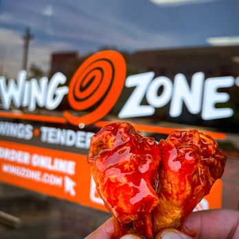 Wing Zone - a hand holding a half eaten donut - Chicken Wings Near Me - Lexington, Kentucky Wing Zone - a hand holding a half eaten donut - Chicken Wings Near Me - Lexington, Kentucky