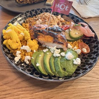 Nando's Peri-Peri - Rainbow bowl -- came with cauliflower, avocado slides, cucumber-pickled onion salad, hummus - Chicken Shop Near Me - Houston, Texas