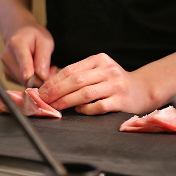 Sato Omakase - a person chopping meat on a cutting board - Sushi Bars Near Me - San Francisco, California Sato Omakase - a person chopping meat on a cutting board - Sushi Bars Near Me - San Francisco, California