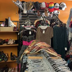 Closet Freaks Resale Boutique - Assortment of dresses when you first walk in on the right and hat above
