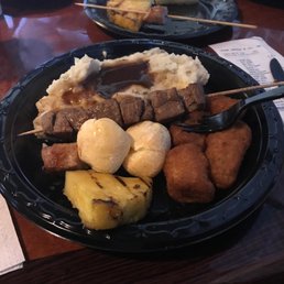 Grilled steak skewer with fried bananas, cheese rolls and pineapple Grilled steak skewer with fried bananas, cheese rolls and pineapple