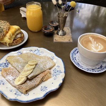 Clayton's Bakery & Bistro - Egg, House Sausage and Cheddar Bagel with Nutella, Peanut Butter and Banana Crepe, orange juice and latte - Bakeries Near Me - Coronado, California Clayton's Bakery & Bistro - Egg, House Sausage and Cheddar Bagel with Nutella, Peanut Butter and Banana Crepe, orange juice and latte - Bakeries Near Me - Coronado, California