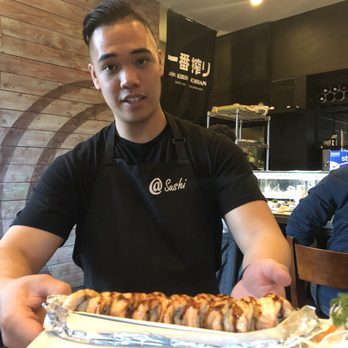 @Sushi - Calvin delivering the roll he convinced us to try (Baked Salmon? I forgot the name, but remembered the flavor!! - Sushi Bars Near Me - Long Beach, California