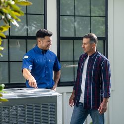 Home Comfort Experts - HCE tech discussing AC options with customer