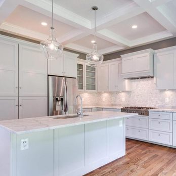 Concept Design Pro - a kitchen with white cabinets and wood floors - General Contractors Near Me - McLean, Virginia Concept Design Pro - a kitchen with white cabinets and wood floors - General Contractors Near Me - McLean, Virginia