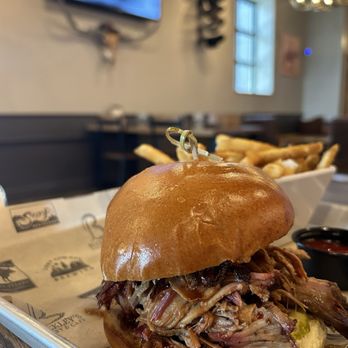 Lost Cowboy Brewing - Pulled pork sandwich with spicy pickles and fries. - Brewpubs Near Me - Nashua, New Hampshire Lost Cowboy Brewing - Pulled pork sandwich with spicy pickles and fries. - Brewpubs Near Me - Nashua, New Hampshire