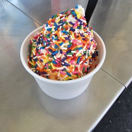 Orange vanilla soft serve with rainbow sprinkles Orange vanilla soft serve with rainbow sprinkles