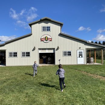 Jonamac Orchard - two children playing in front of a barn - Fruits & Veggies Near Me - Malta, Illinois