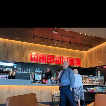 Starbucks - a man standing in front of a counter - Coffee & Tea Near Me - Delray Beach, Florida