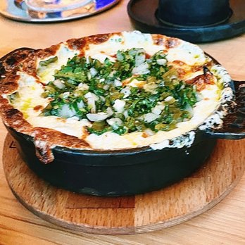 ATX Cocina - Queso Fundido. The pickled chilies mixed in and on top give a nice flavor to the cheese base. Ask for extra tortillas. - Mexican Near Me - Austin, Texas