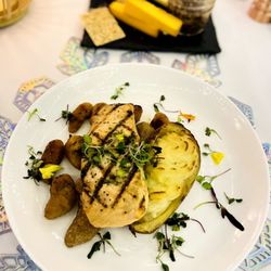 Grilled atlantic salmon, tarragon butter within truffle twice baked potato and pumpkin gnocchi, sage butter