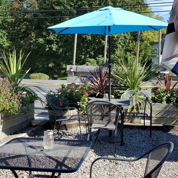 Woodfire Kitchen - a patio with chairs and umbrellas - Pizza Near Me - Parkton, Maryland