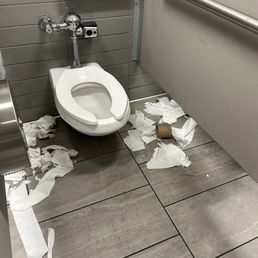 All bathroom stalls dirty used toilet paper on floor in corners, no seat covers and replacement toilet papers stored on the dirty floor. All bathroom stalls dirty used toilet paper on floor in corners, no seat covers and replacement toilet papers stored on the dirty floor.