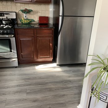 Sheridan's Wood Floors - a kitchen with stainless steel appliances - Refinishing Services Near Me Sheridan's Wood Floors - a kitchen with stainless steel appliances - Refinishing Services Near Me