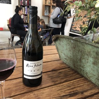 Bay Grape - Sitting at the wooden table - Beer, Wine & Spirits Near Me - Oakland, California