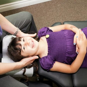 Center for Chiropractic + Wellness - Dr. Megan treating a young patient. - Chiropractors Near Me - Portland, Oregon