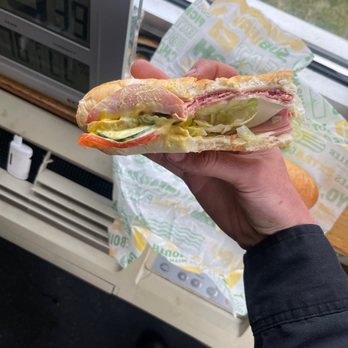 Subway - a person holding a sandwich in front of a window - Sandwiches Near Me - Rogers, Minnesota