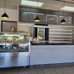 Estilo Campo Empanadas Argentinas and Bakery - Displayed pastries & menu board.