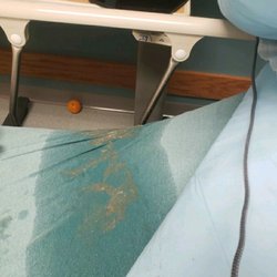 Henry Ford Wyandotte Hospital Emergency Department - Bed where I layed in my own vomit for over 2 hours and yes that is a filthy food covered floor