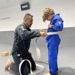 Alliance Jiu Jitsu - Northwest Arkansas - Leading by example--Professor promoting another student to the next rank. Growth, dedication, and tradition on the mats.