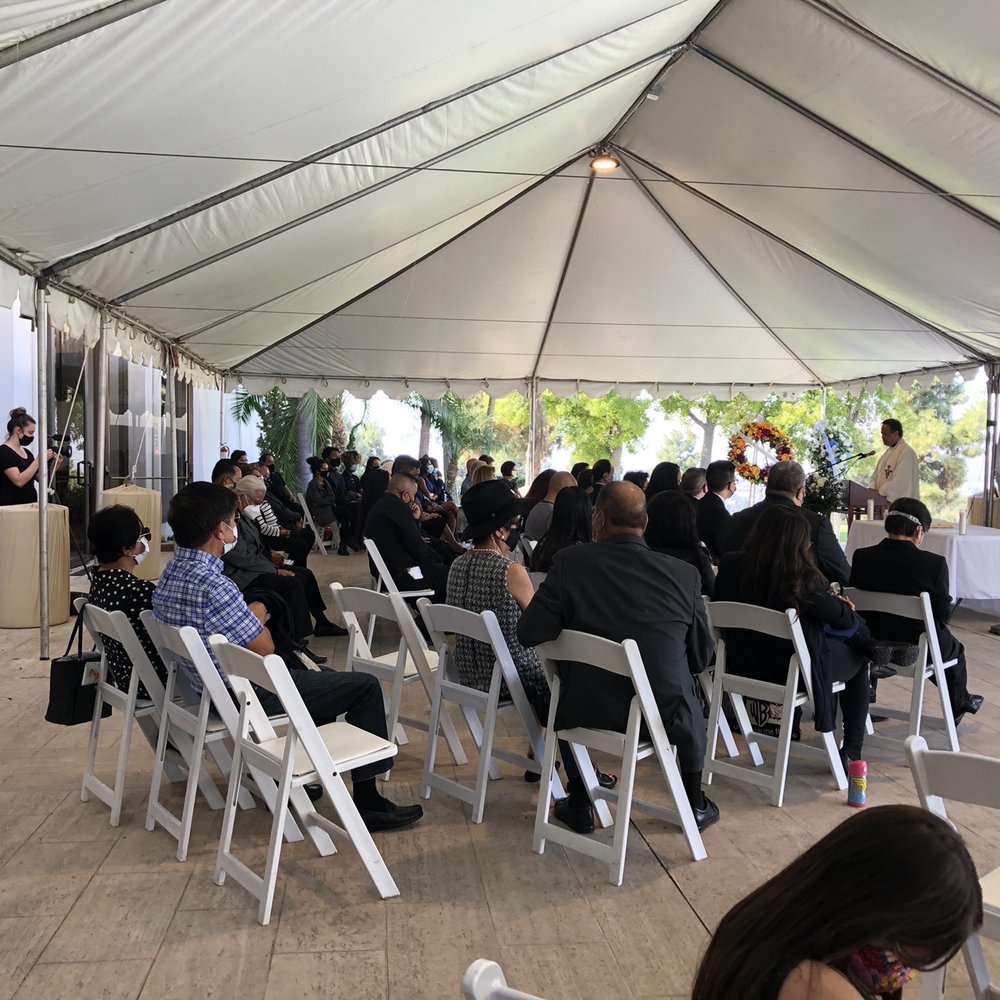 Stephanie (Shore and Wave) set up in the back of the tented area during the Catholic Funeral Mass at Rose Hills Memorial Chapel.