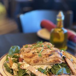 a plate of chicken and spinach salad