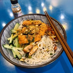 Crispy Salmon over rice noodles with fresh salad and crunchy peanuts