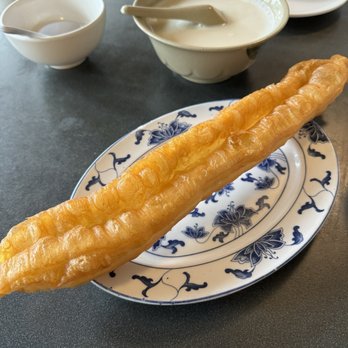 Chung Shin Yuan - Youtiao (Chinese fried dough) (front), and sweet soybean milk (back) - Chinese Near Me - Newton, Massachusetts Chung Shin Yuan - Youtiao (Chinese fried dough) (front), and sweet soybean milk (back) - Chinese Near Me - Newton, Massachusetts