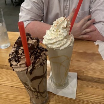 Burger Republic - a man sitting at a table with two milkshakes - Burgers Near Me - Nashville, Tennessee